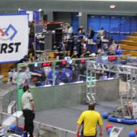 Event staff prepare for a match to start